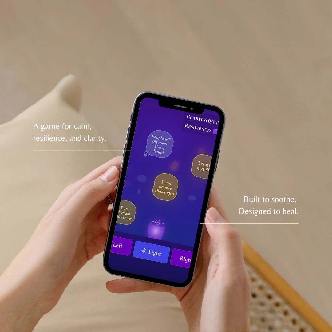 Hand holding mobile device with Worry Hunter game interface